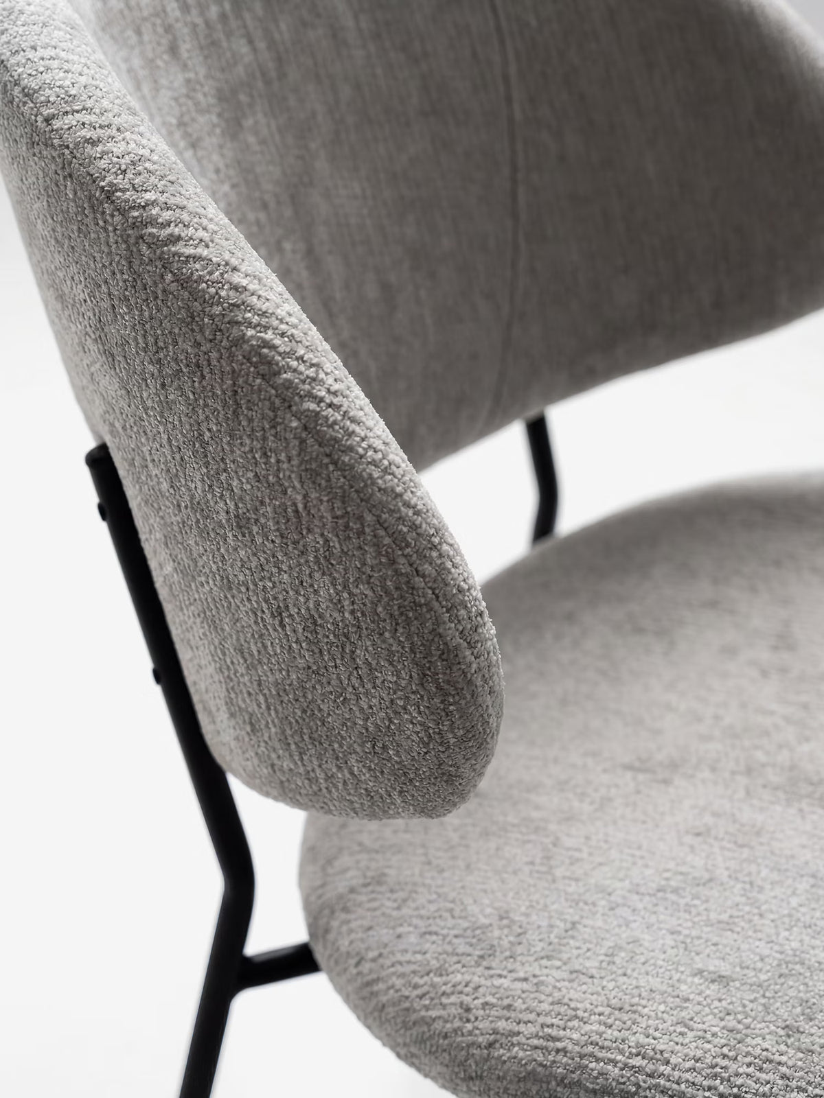 Bruma chair in elegant grey fabric with black metal legs - minimalist design and wraparound backrest