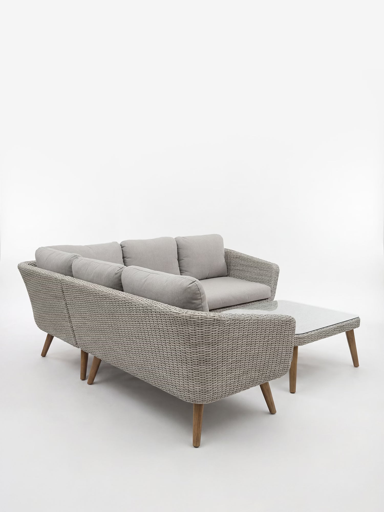 Leya Set angolare da esterno in wicker grigio con tavolino con top in vetro temperato
