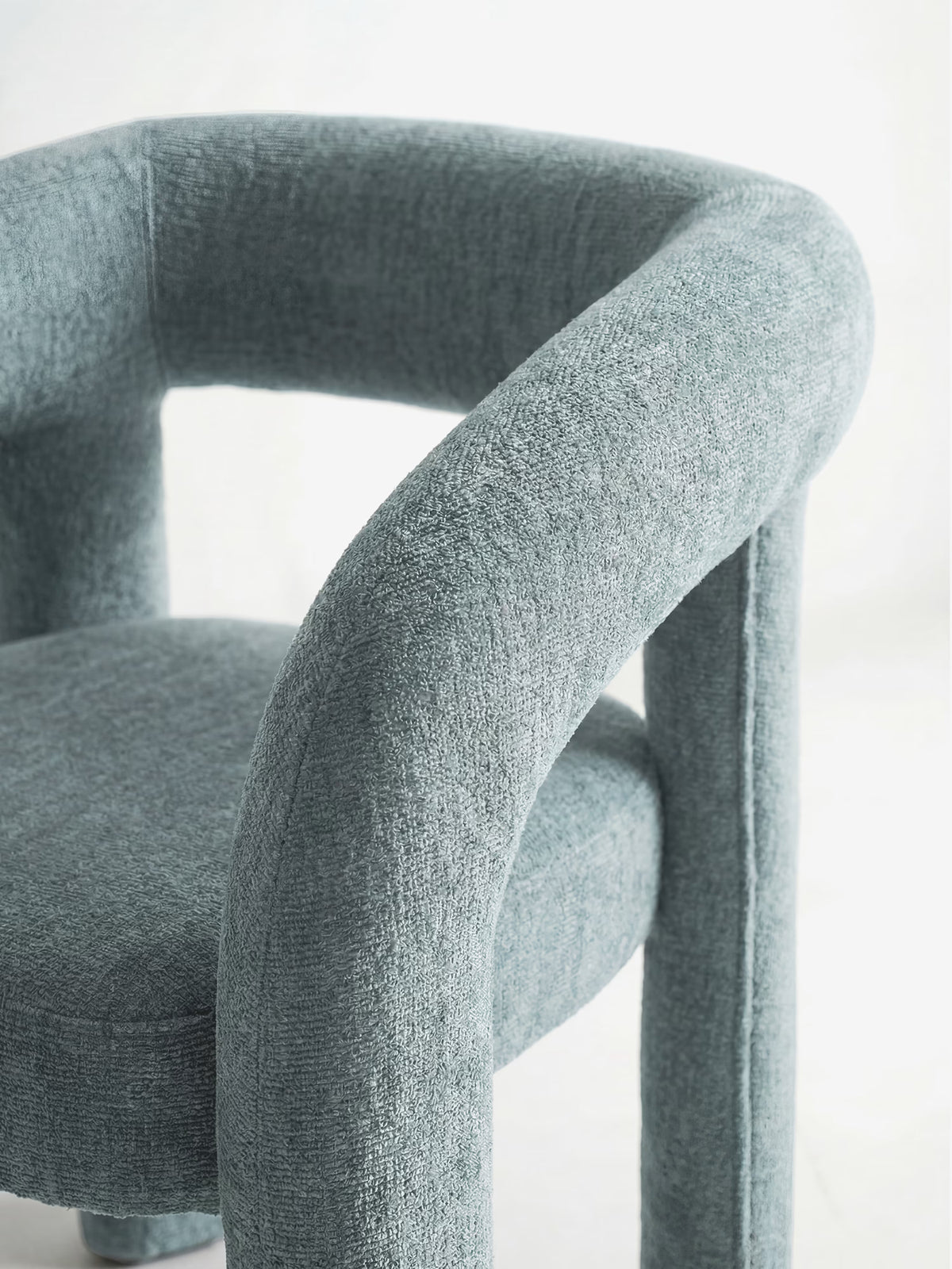 Sibilla upholstered green chenille fabric designer chair with upholstered frame and arch shape