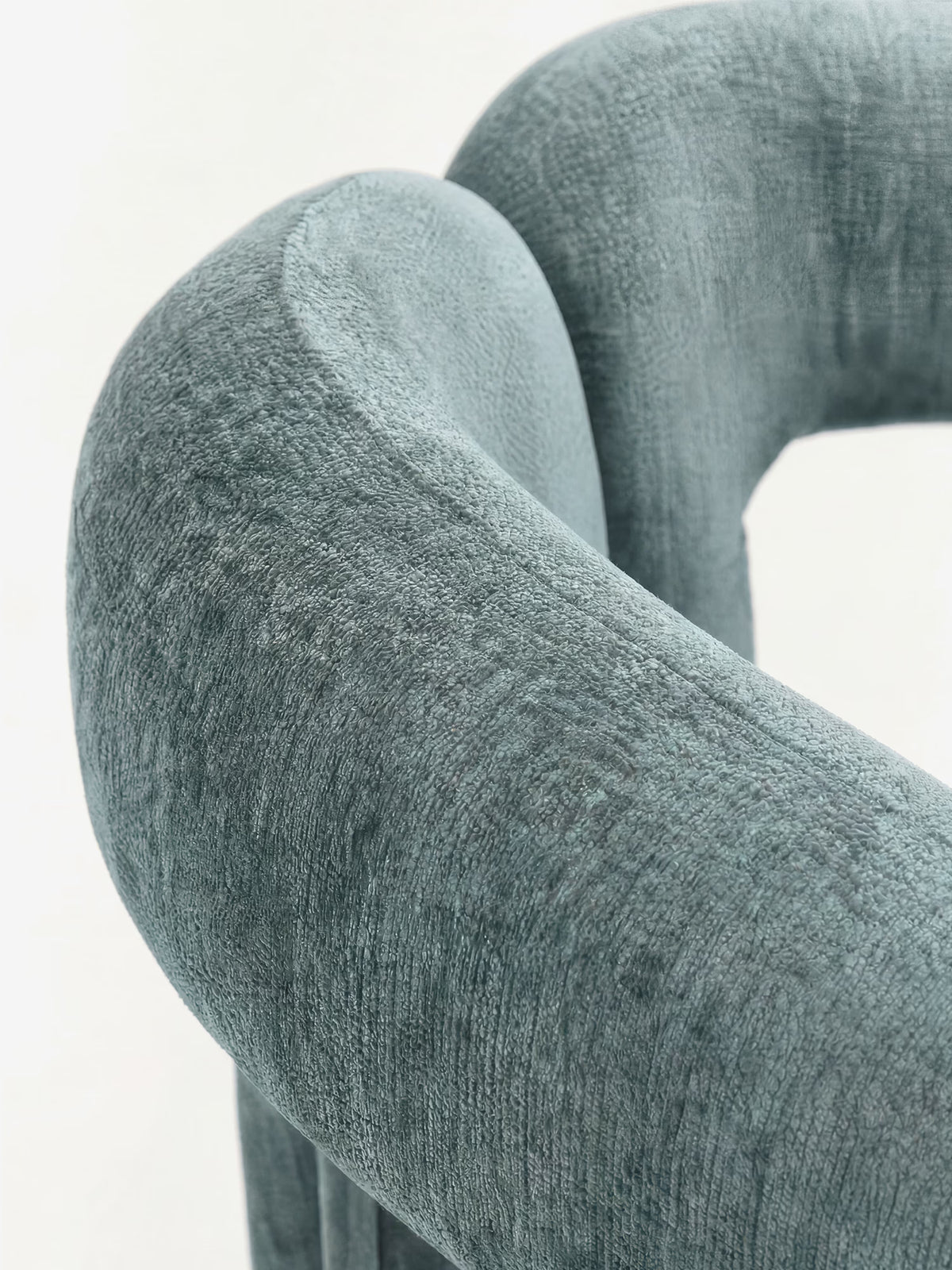 Sibilla upholstered green chenille fabric designer chair with upholstered frame and arch shape