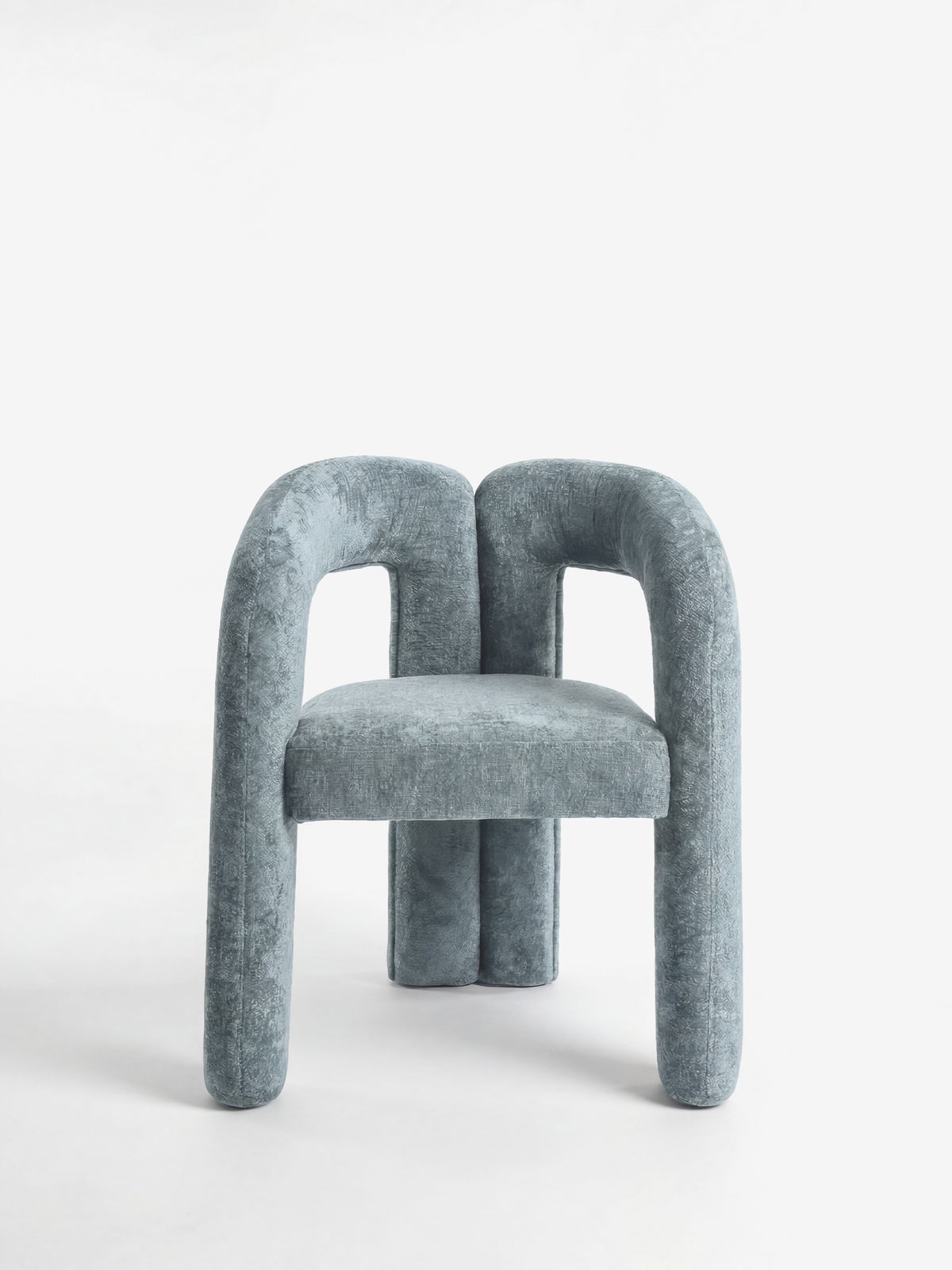 Sibilla upholstered green chenille fabric designer chair with upholstered frame and arch shape