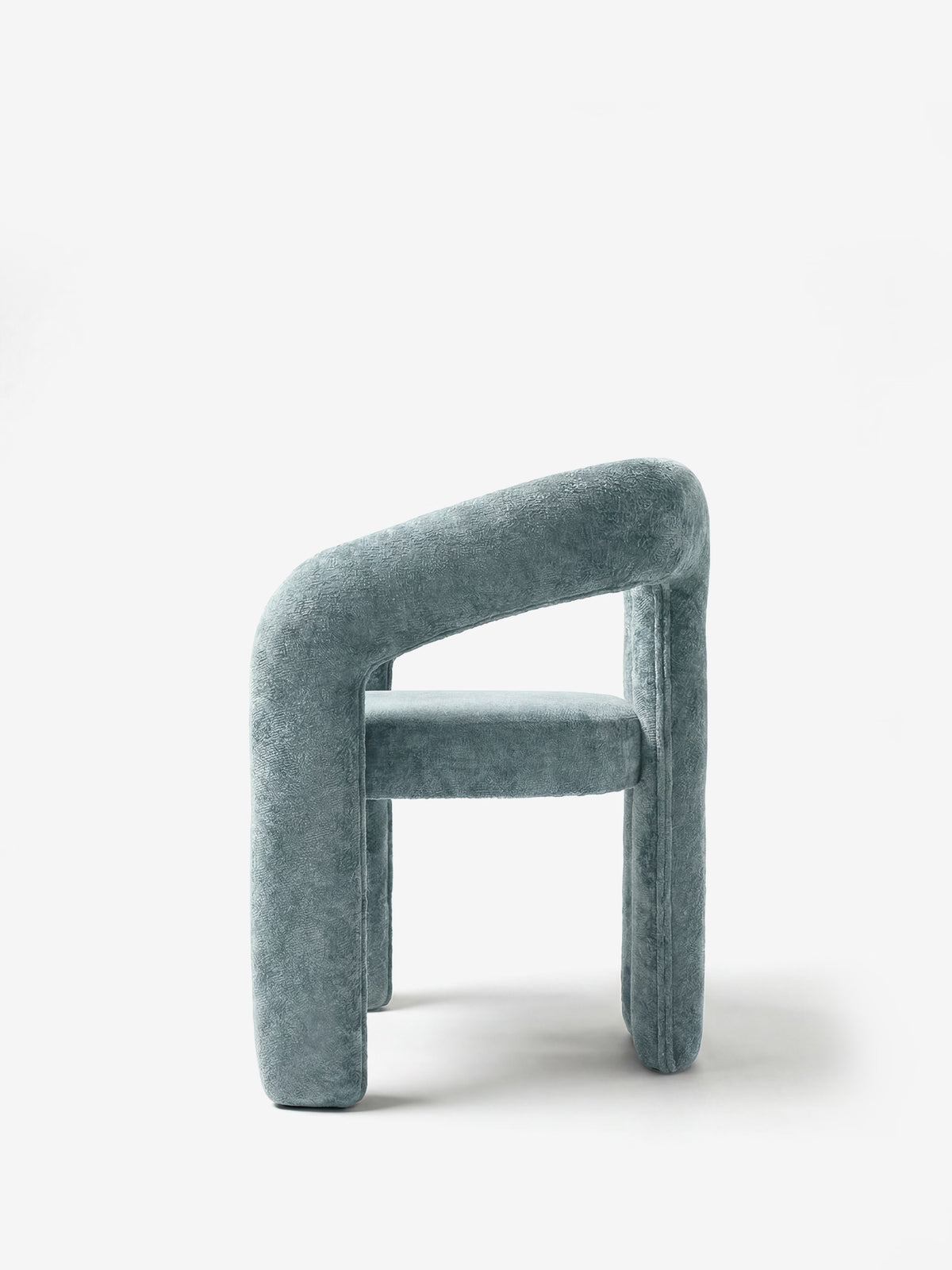 Sibilla upholstered green chenille fabric designer chair with upholstered frame and arch shape
