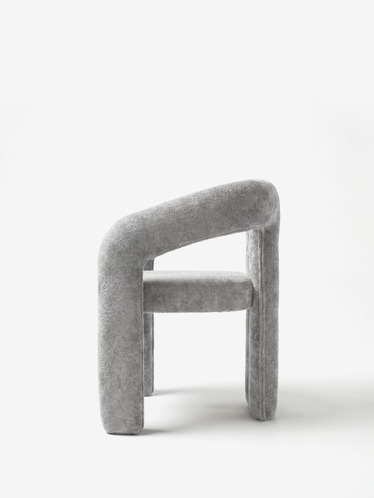 Sibilla upholstered green chenille fabric designer chair with upholstered frame and arch shape